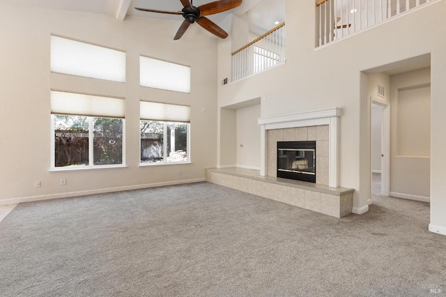 2550 Duncan St, Dixon, CA 95620 - unfurnished living room featuring ceiling fan, carpet, a towering ceiling, a tile fireplace, and beamed ceiling