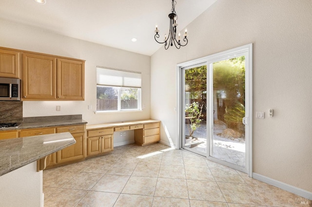 2550 Duncan St, Dixon, CA 95620 - kitchen featuring stainless steel appliances, vaulted ceiling, healthy amount of natural light, pendant lighting, and a chandelier