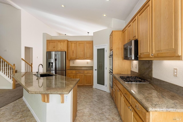 2550 Duncan St, Dixon, CA 95620 - kitchen with stainless steel appliances, a sink, light tile patterned flooring, stone counters, and a breakfast bar area