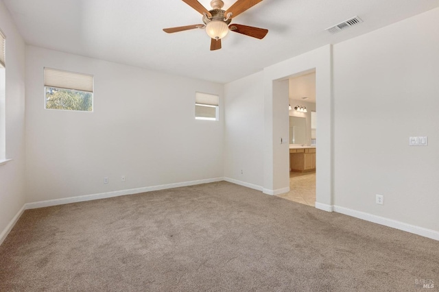 2550 Duncan St, Dixon, CA 95620 - empty room with light colored carpet, healthy amount of natural light, a ceiling fan, and baseboards