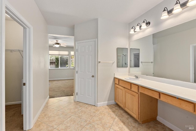 2550 Duncan St, Dixon, CA 95620 - bathroom featuring vanity, baseboards, tile patterned flooring, and a spacious closet