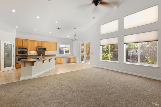 2550 Duncan St, Dixon, CA 95620 - kitchen featuring appliances with stainless steel finishes, light carpet, a chandelier, a breakfast bar area, and recessed lighting