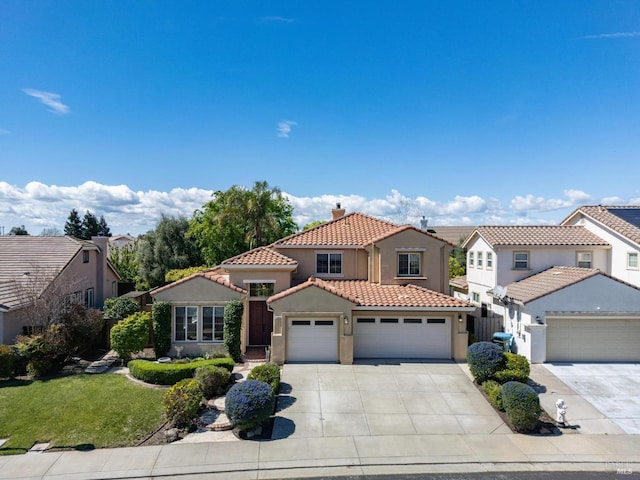 2550 Duncan St, Dixon, CA 95620 - mediterranean / spanish home with stucco siding, a tiled roof, driveway, an attached garage, and a chimney