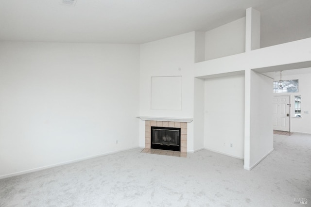 unfurnished living room with baseboards, a fireplace, and carpet flooring