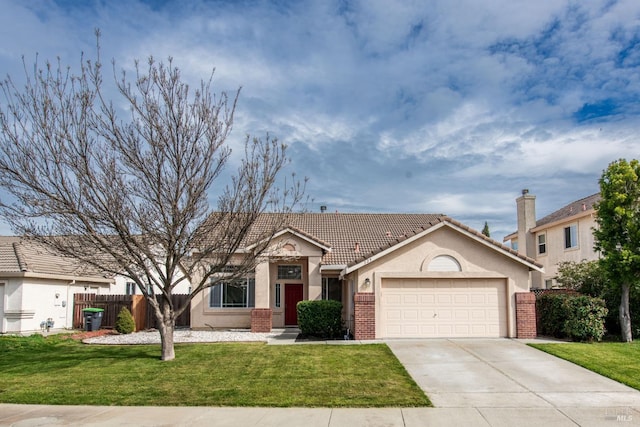 view of front of home featuring fence, a front lawn, concrete driveway, a garage, and brick siding