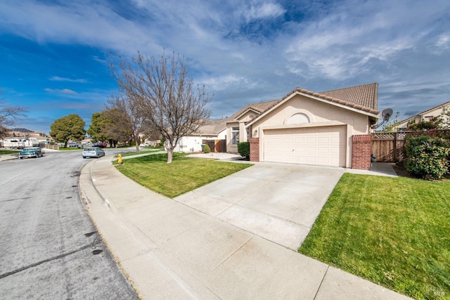 view of front of house featuring fence, driveway, stucco siding, a front lawn, and a garage