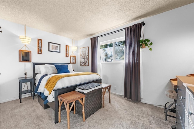 bedroom featuring a textured ceiling, baseboards, and light carpet