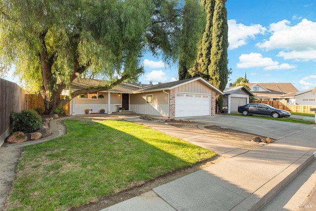 ranch-style house with fence, driveway, a front lawn, a garage, and brick siding