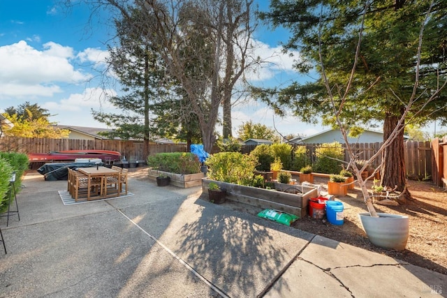 view of patio / terrace featuring a vegetable garden and a fenced backyard