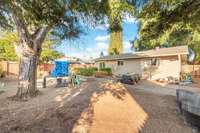 back of property featuring stucco siding, a patio area, and fence