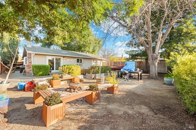 view of patio featuring cooling unit, a fire pit, and fence