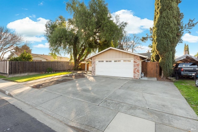 ranch-style house with fence, board and batten siding, concrete driveway, a garage, and brick siding