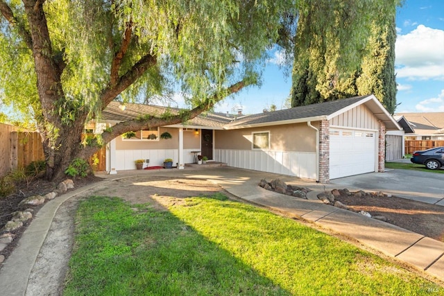 ranch-style home featuring driveway, a garage, and fence