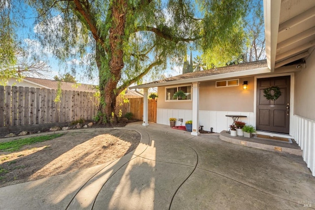 exterior space featuring stucco siding, a patio, and fence