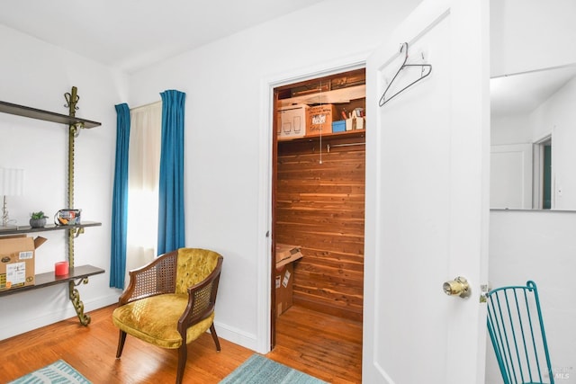 living area with wood finished floors and baseboards