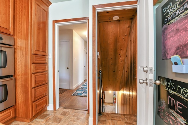 interior space with baseboards and stone finish floor