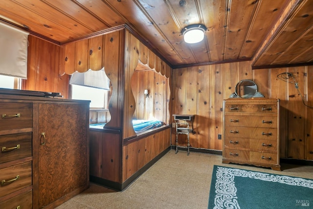 bedroom featuring wooden ceiling, wooden walls, and light floors