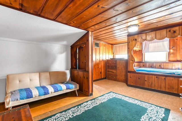 bedroom with tile patterned floors, visible vents, wood walls, wood ceiling, and vaulted ceiling