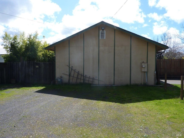 view of outbuilding featuring fence