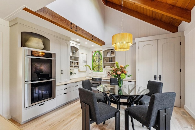 dining area featuring vaulted ceiling with beams, wood ceiling, and light wood-type flooring