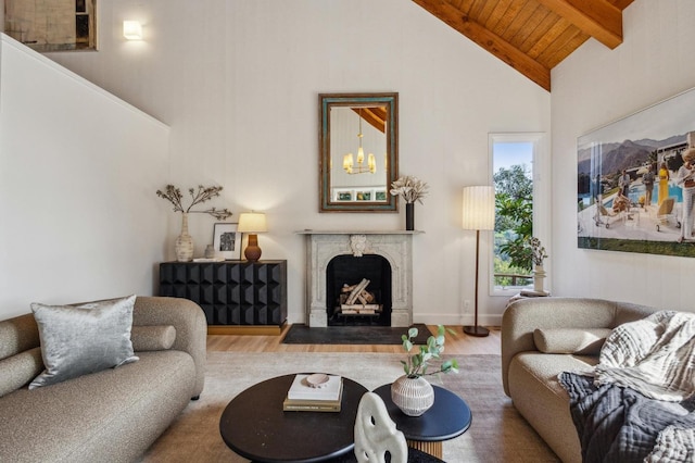 living area featuring a high end fireplace, beamed ceiling, high vaulted ceiling, and wood finished floors