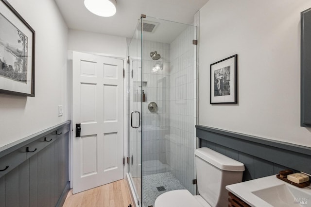 full bathroom featuring visible vents, toilet, a stall shower, wood finished floors, and vanity