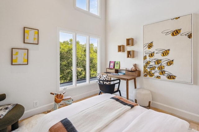 bedroom with multiple windows and baseboards