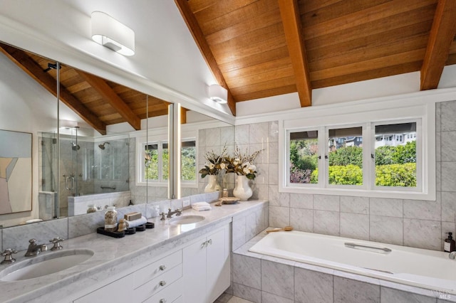 full bath with a stall shower, lofted ceiling with beams, and a sink