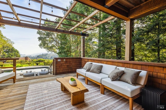 wooden deck with outdoor lounge area and a pergola