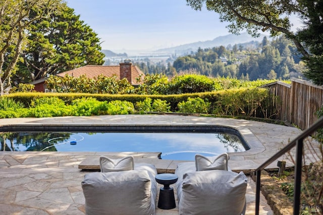 view of swimming pool with a fenced in pool and fence