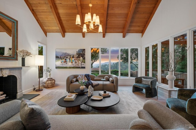 living room featuring a fireplace with flush hearth, a notable chandelier, beam ceiling, and wood finished floors