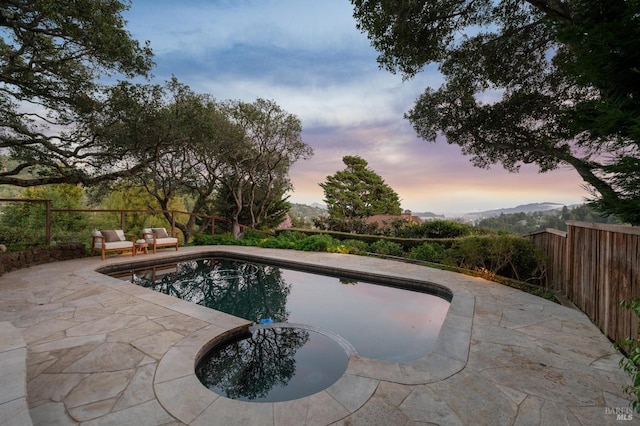 view of swimming pool with a fenced in pool, a patio, and fence