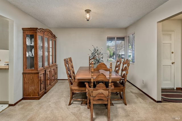 dining area with light carpet and baseboards