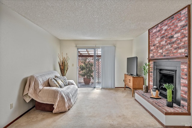 carpeted living area with a fireplace, baseboards, and a textured ceiling