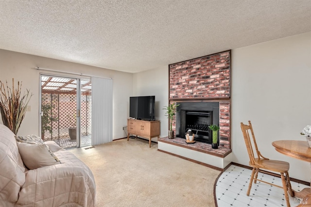 carpeted living area with a fireplace, a textured ceiling, and baseboards