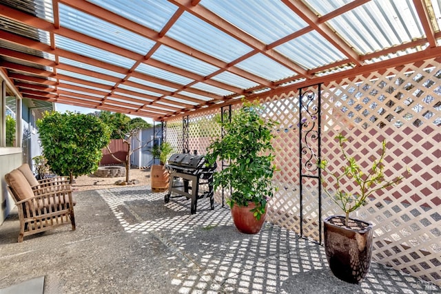 view of patio featuring area for grilling, a pergola, and fence