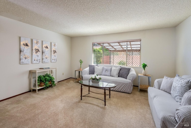 living room with baseboards, a textured ceiling, and carpet flooring