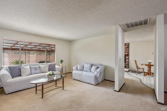 living area with baseboards, visible vents, carpet floors, and a textured ceiling