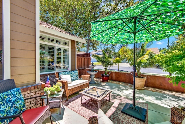 view of patio / terrace featuring an outdoor hangout area and fence