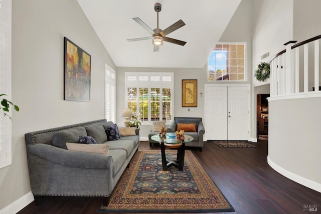 living area with visible vents, high vaulted ceiling, a ceiling fan, wood finished floors, and baseboards