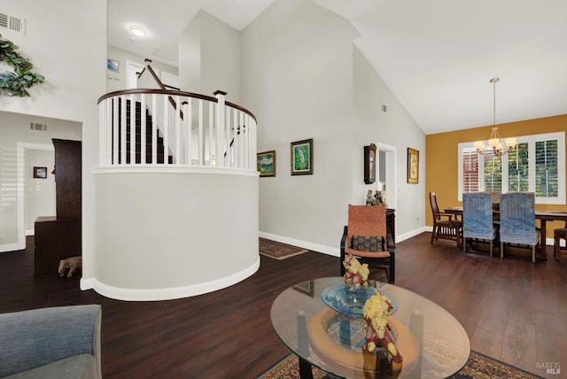 living room with visible vents, stairway, high vaulted ceiling, and an inviting chandelier