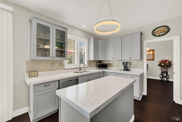 kitchen with a sink, tasteful backsplash, appliances with stainless steel finishes, and gray cabinets