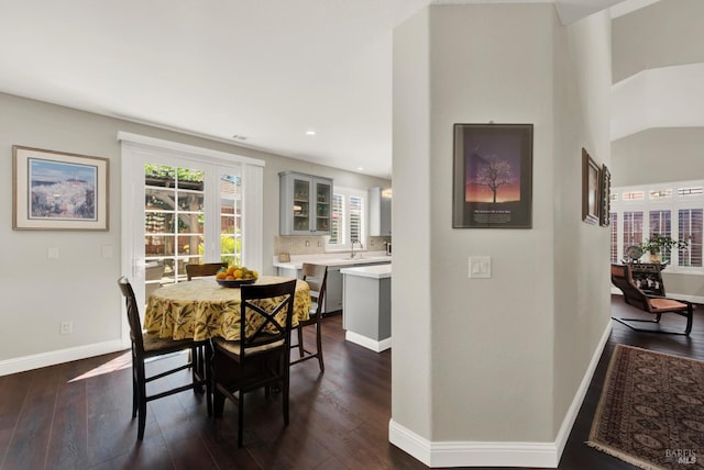 dining area featuring dark wood-style floors and baseboards