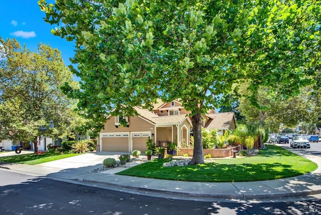 view of front facade featuring driveway, an attached garage, a front lawn, and a tile roof