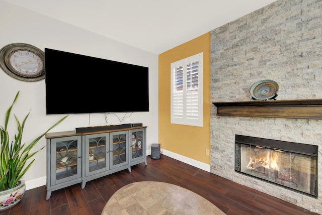 living room with a fireplace, wood finished floors, and baseboards