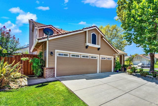 view of front of home with brick siding, driveway, and fence