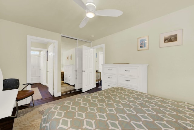 bedroom featuring dark wood finished floors, a closet, ensuite bathroom, and ceiling fan