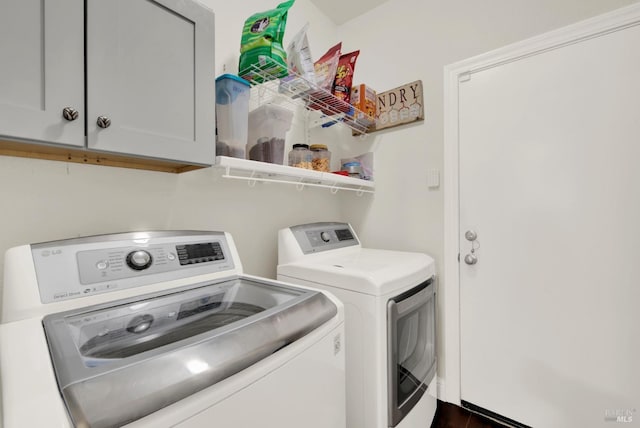 laundry area with cabinet space and washer and clothes dryer