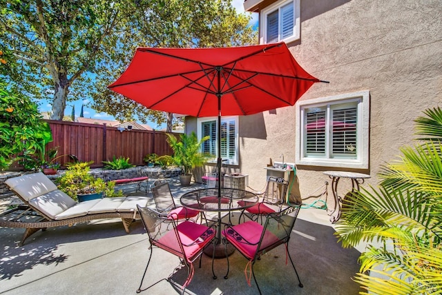 view of patio / terrace featuring outdoor dining space and fence