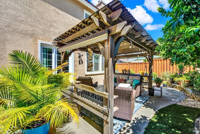 view of patio with an outdoor living space, a gazebo, and fence